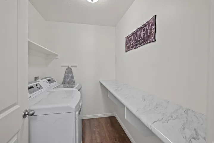 Built-in white shelving, wood-finish flooring, and a white countertop