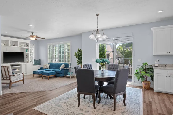 Open-concept living space with wood-finish flooring, recessed lighting, and a ceiling fan
