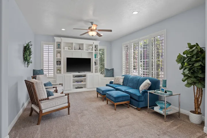 Integrated built-in cabinetry with shelving, recessed lighting, and a ceiling fan