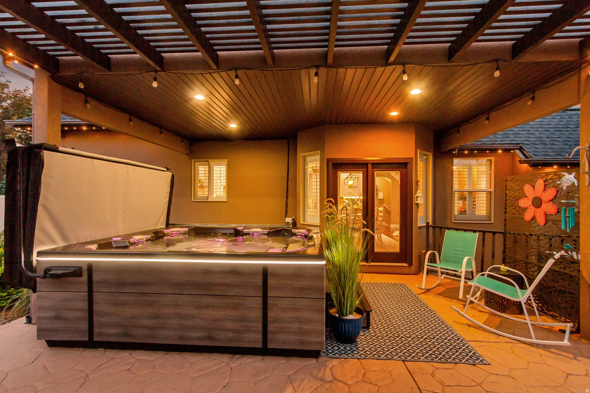Covered patio featuring a built-in hot tub, recessed lighting, and double glass doors