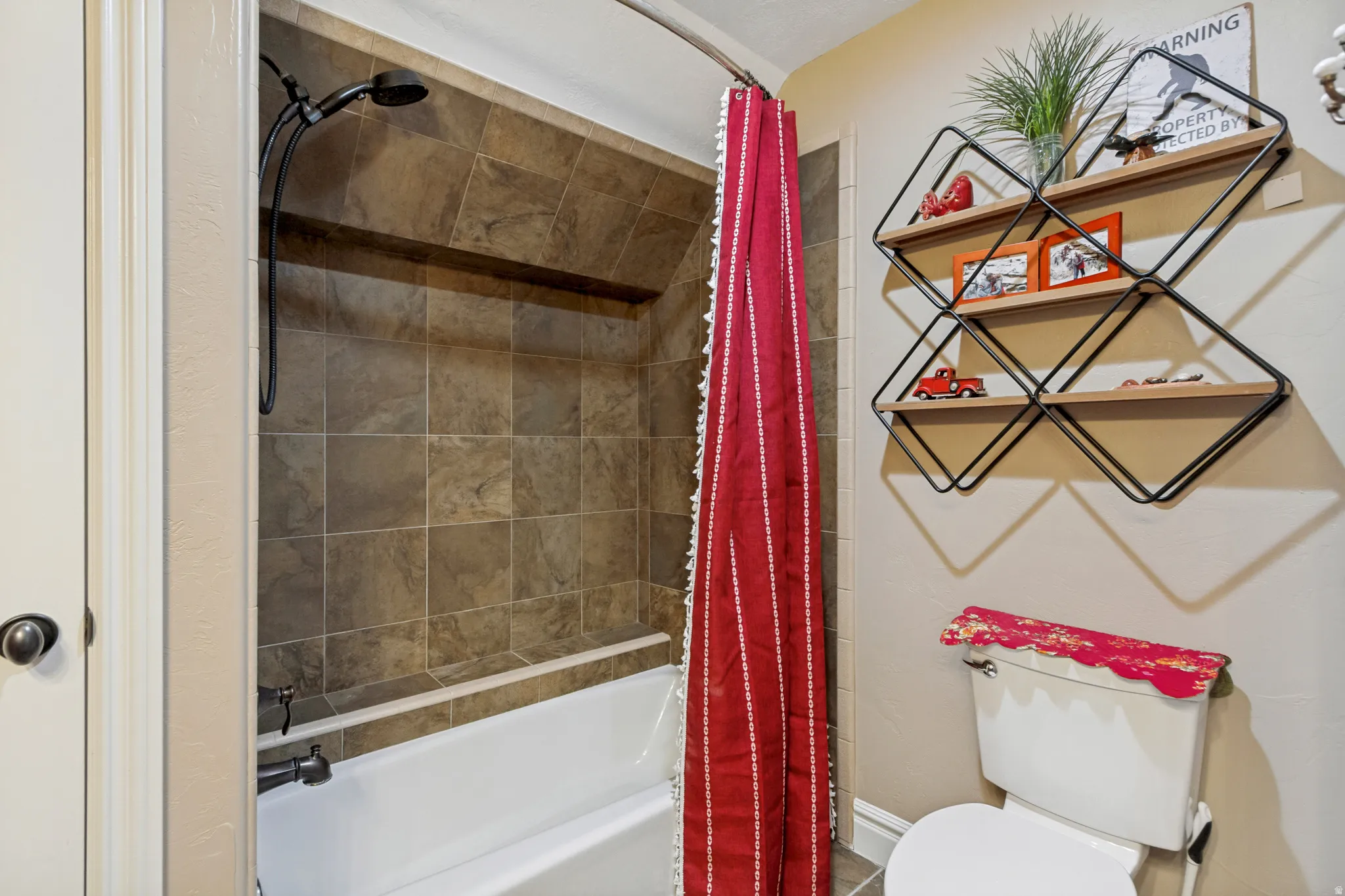 Bathtub with tile surround and dark bronze shower fixtures