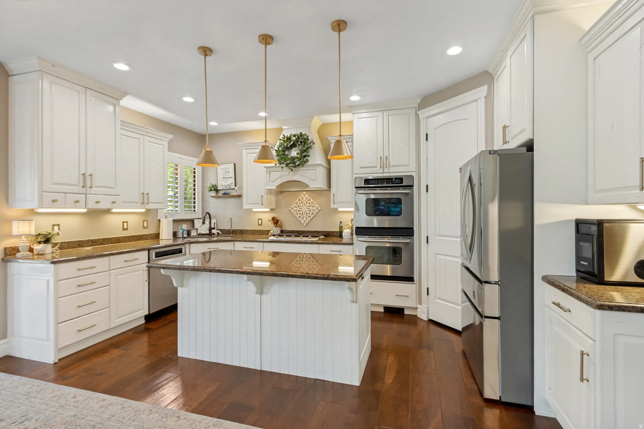 Kitchen featuring white cabinetry, wood-finish flooring, recessed lighting, and an island with pendant lighting