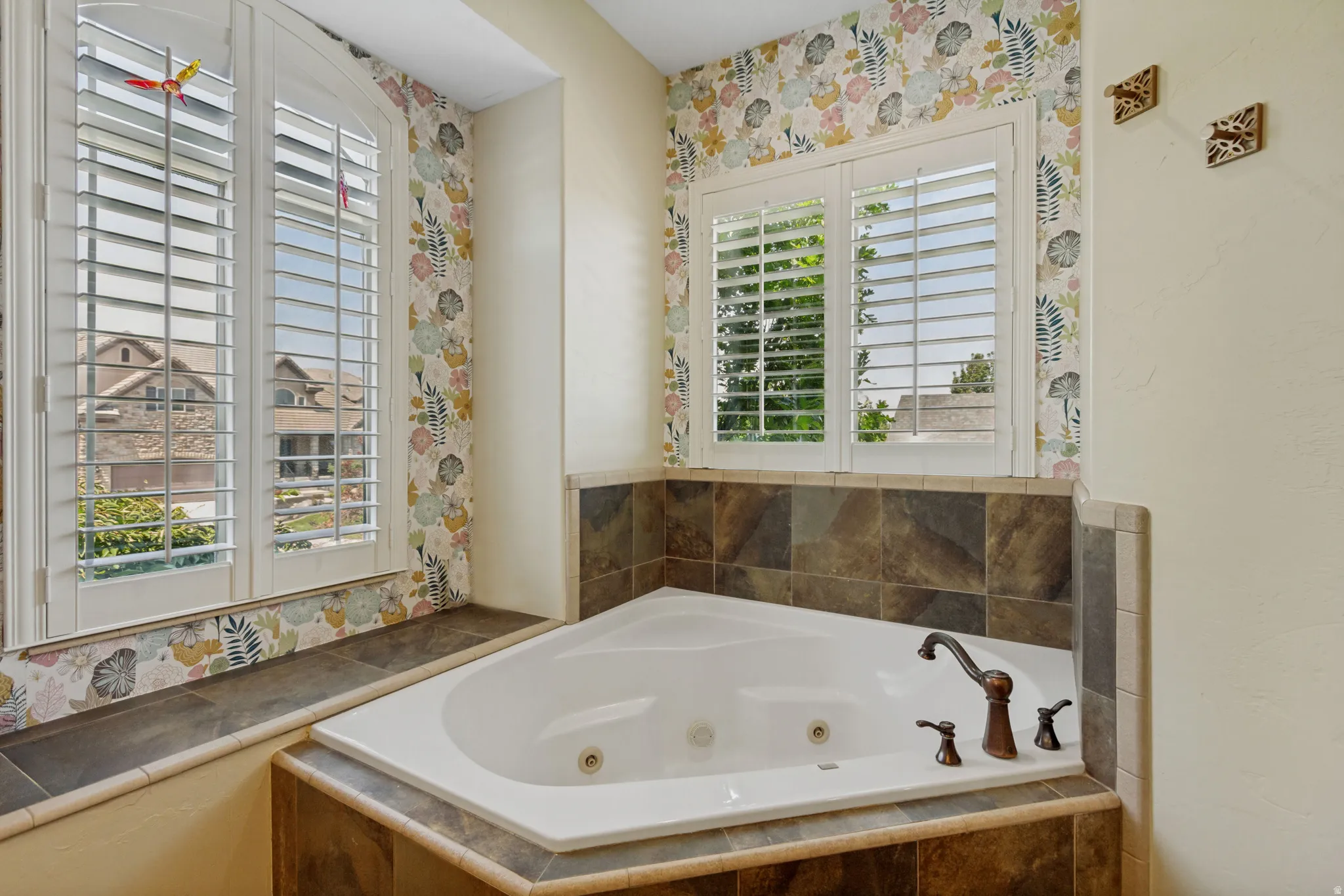 Corner soaking tub featuring an oil-rubbed bronze faucet