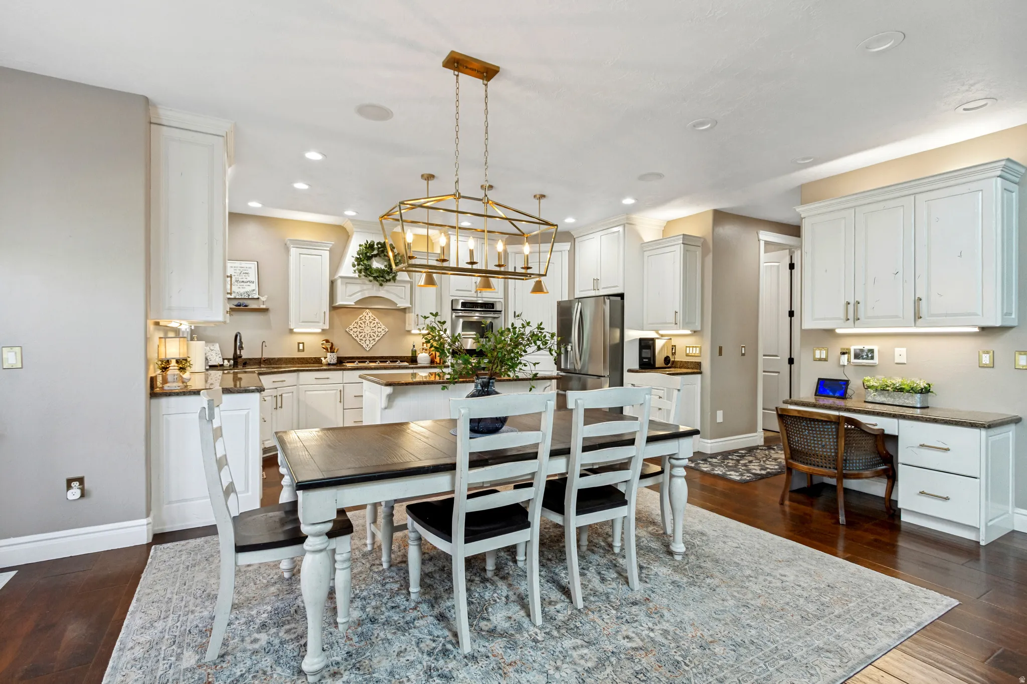 Open-concept kitchen with white cabinetry, a central island, and stainless steel appliances