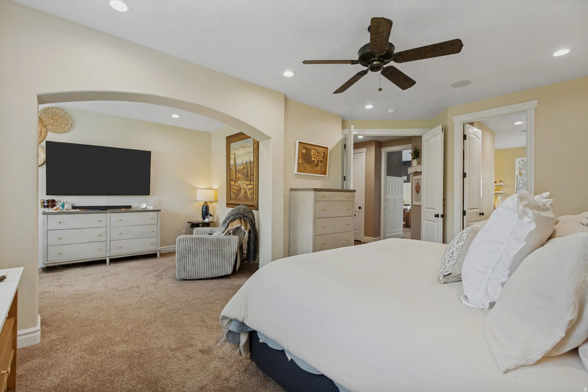 Recessed lighting, arched doorway, ceiling fan, carpeted flooring, white trim work
