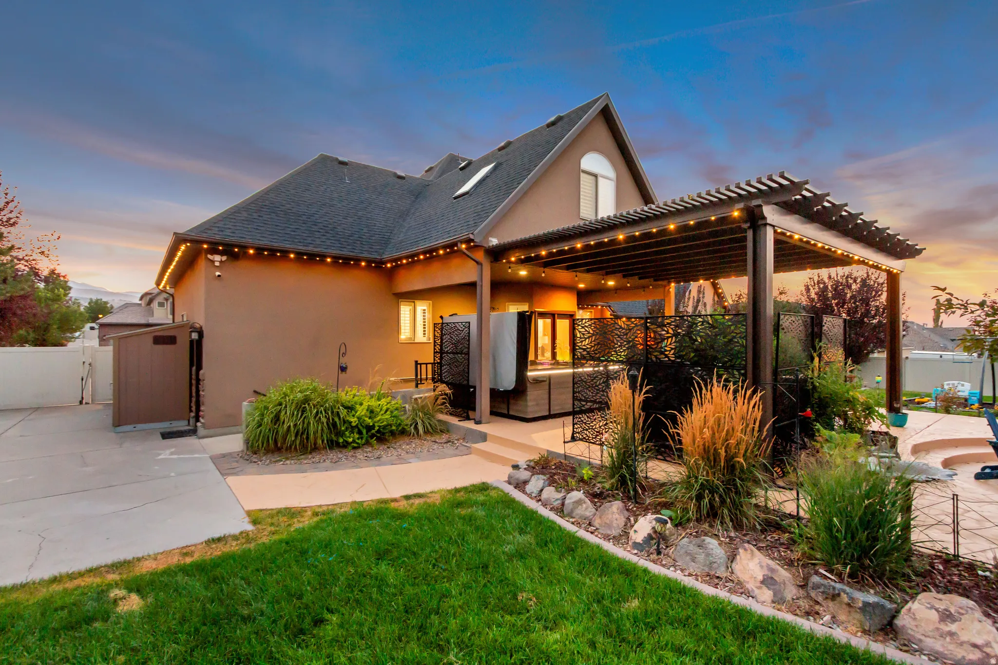 Expansive pergola-covered patio with decorative privacy screens