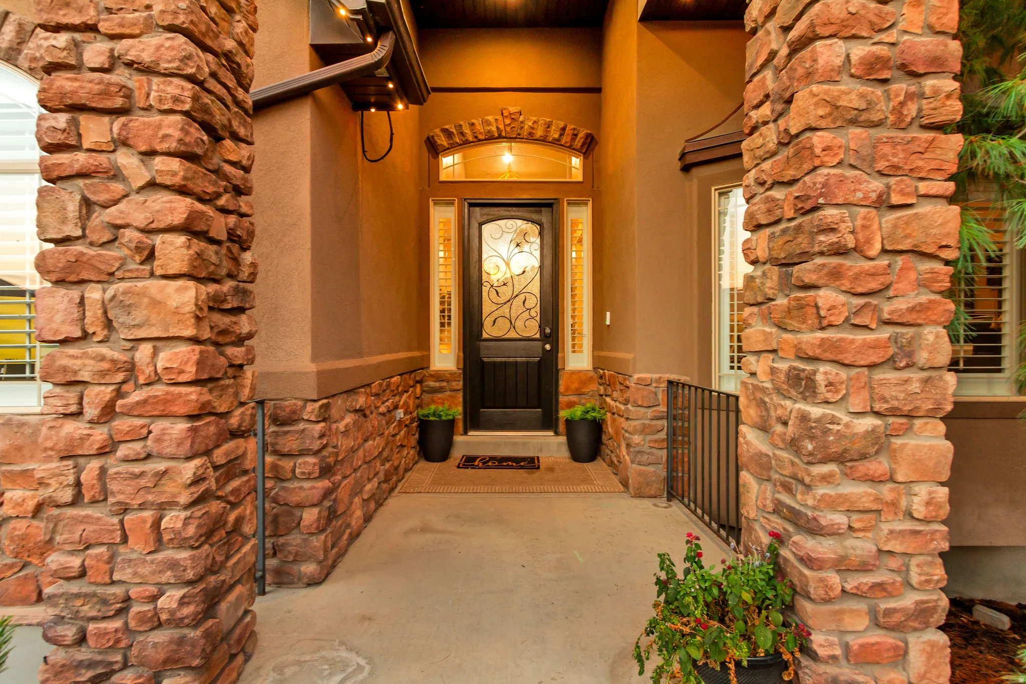 Stone veneer columns and wainscoting enhance the entry