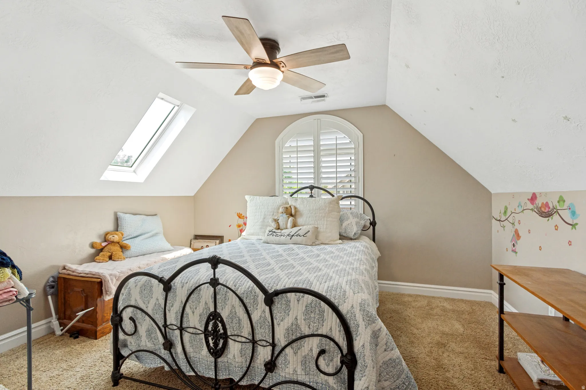 Vaulted ceiling with skylight and ceiling fan