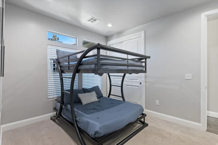 Recessed lighting, light gray wall paint, carpeted flooring, horizontal window blinds, and white interior doors