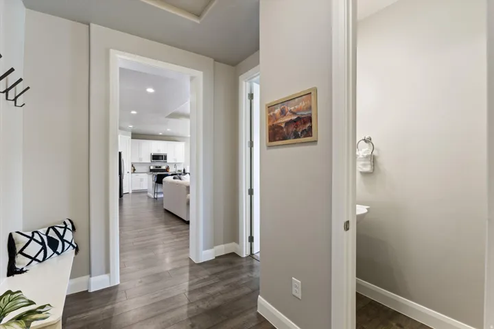 Recessed lighting, wood-finish flooring, white trim, and light gray wall color