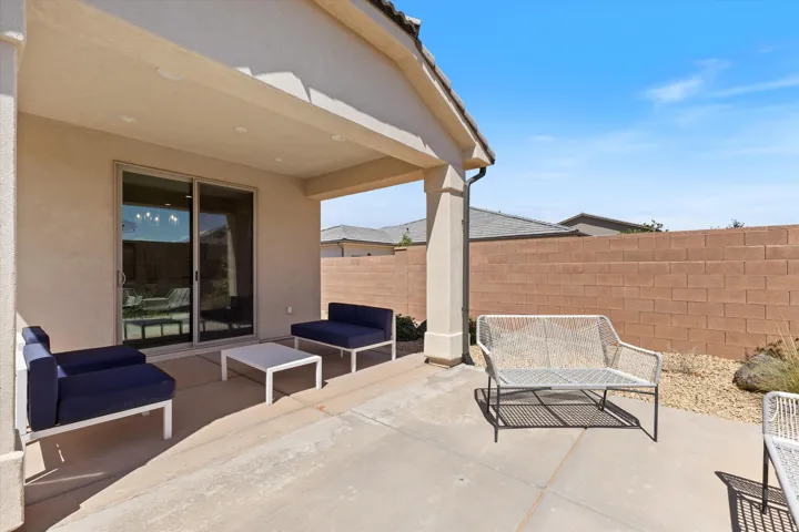 Covered patio featuring concrete flooring and stucco columns