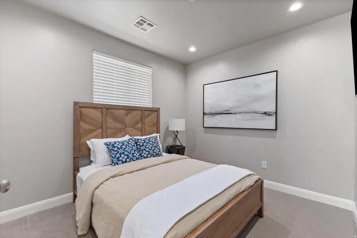 Recessed lighting illuminates neutral-toned walls