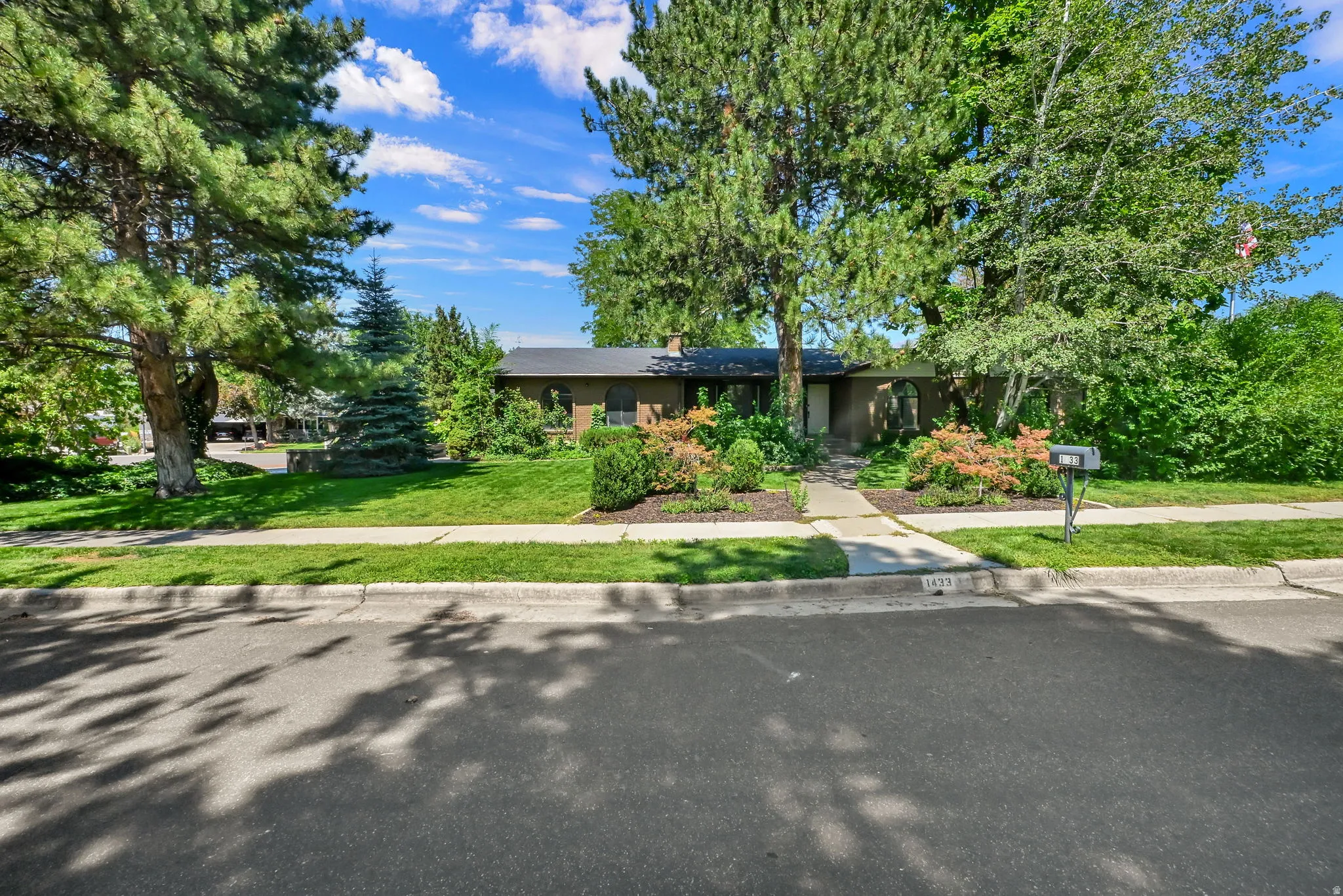 Single-story residence featuring a dark roofline and an arched window