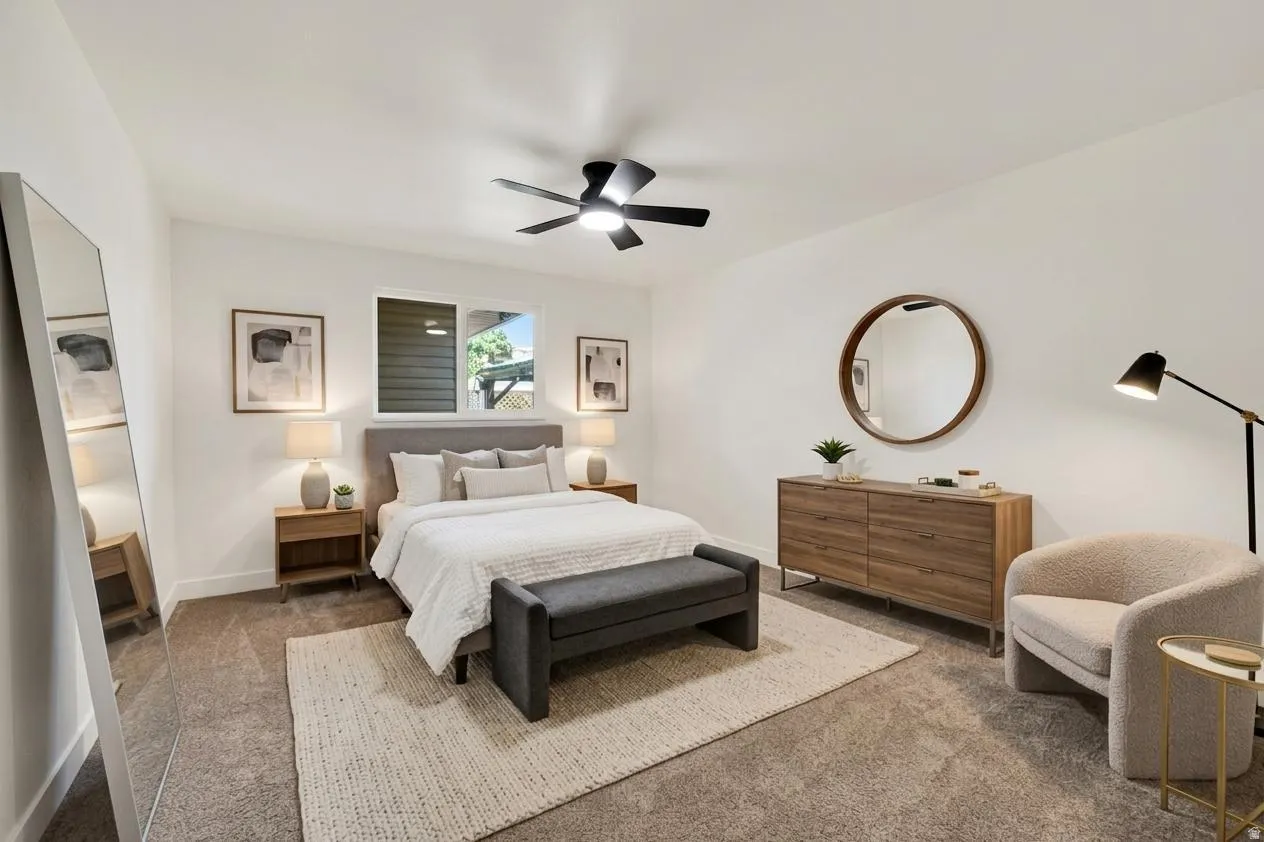 Carpeted flooring, white walls, and a modern ceiling fan with lighting