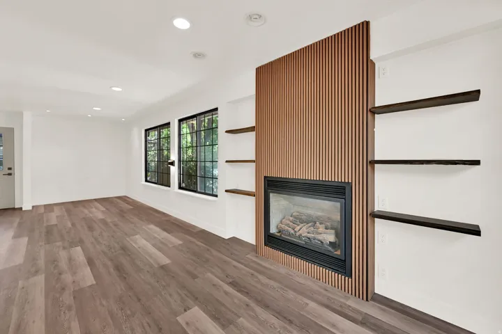 Wood-finish flooring, recessed lighting, and large windows with dark trim