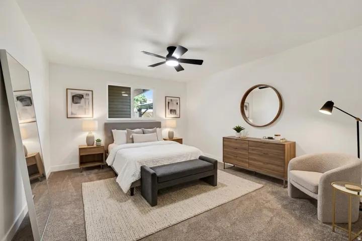 Carpeted flooring, white walls, and a modern ceiling fan with lighting
