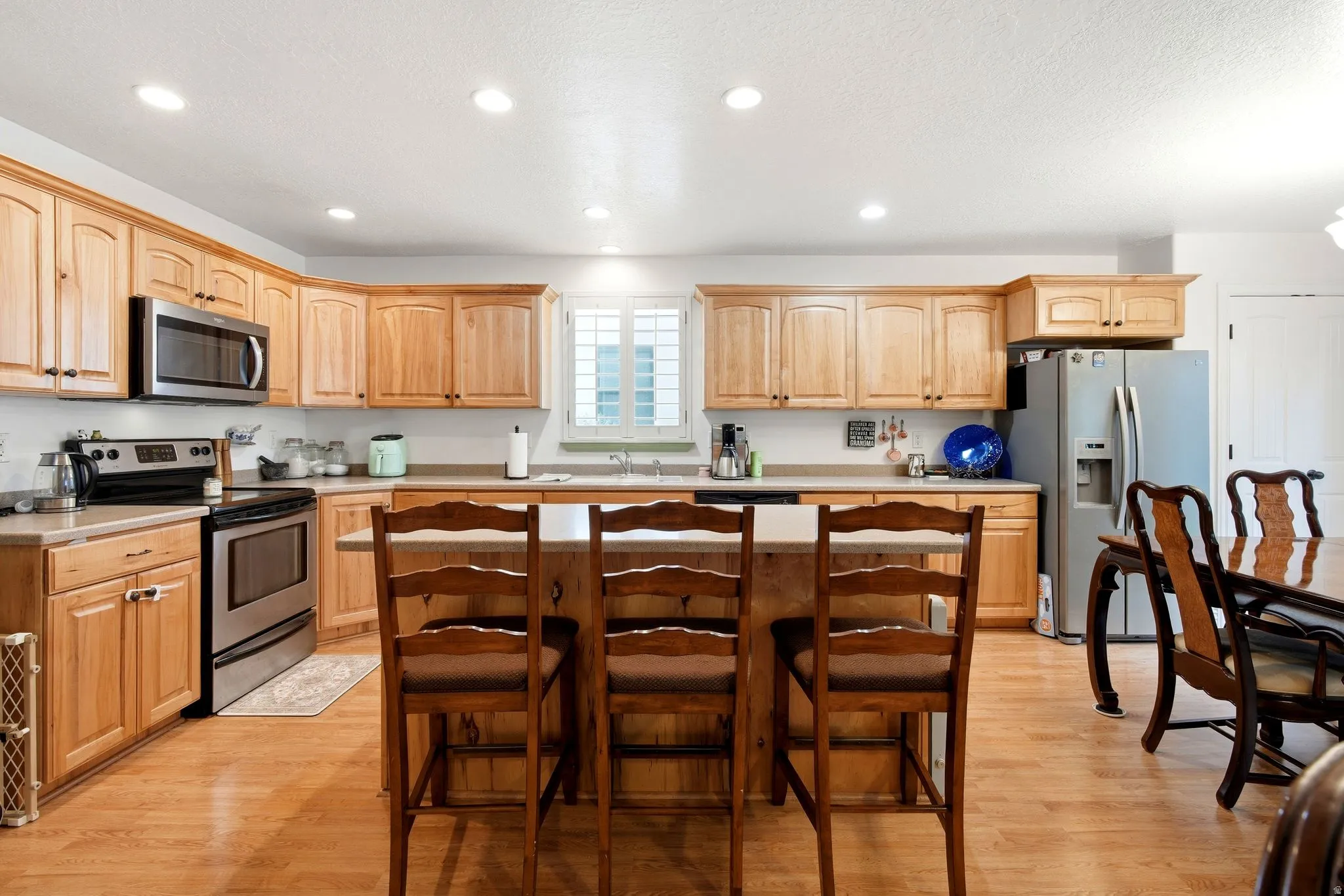 Kitchen featuring wood-finish flooring, recessed lighting, and stainless steel appliances