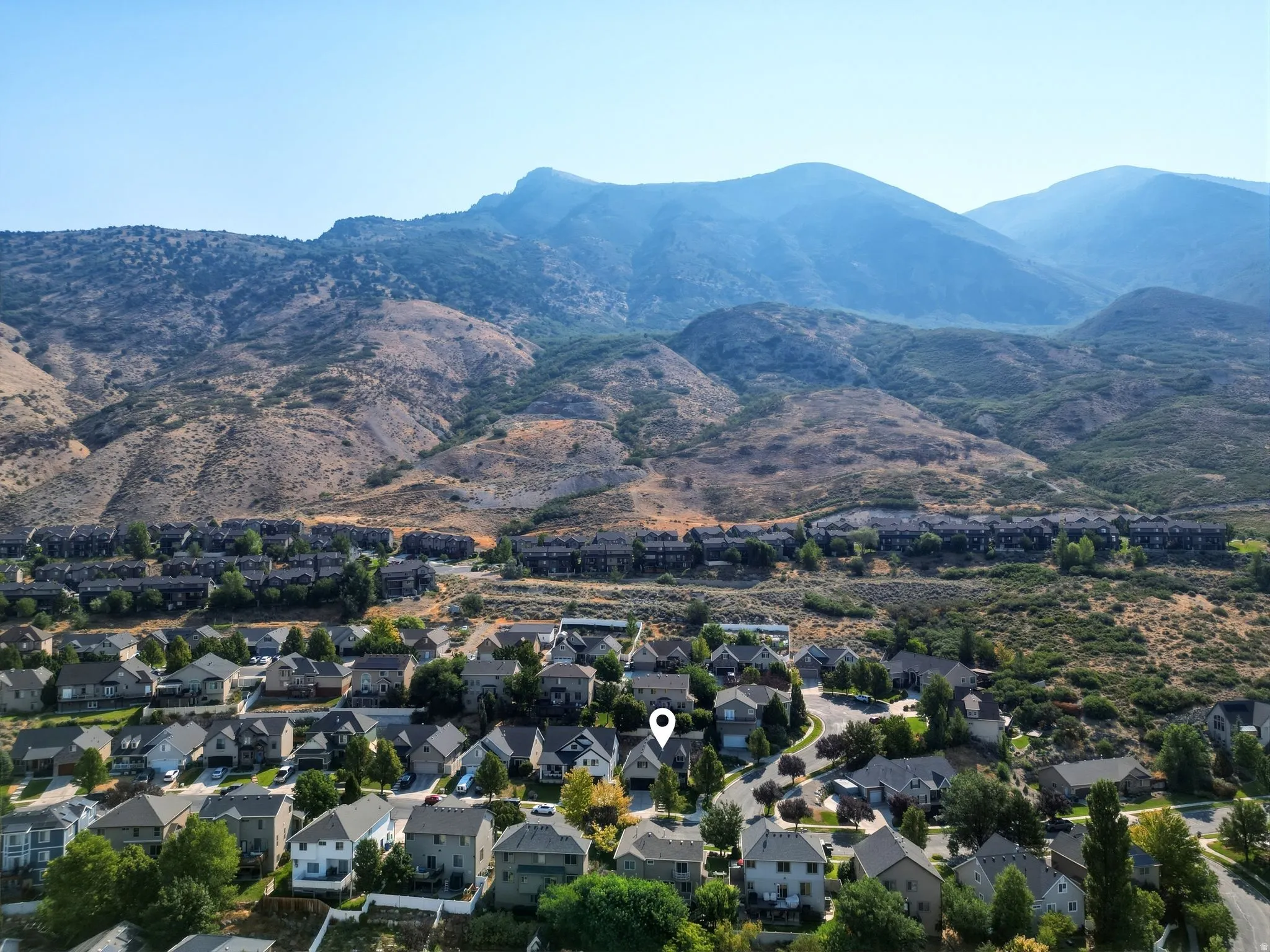 Residential neighborhood situated against a mountainous backdrop