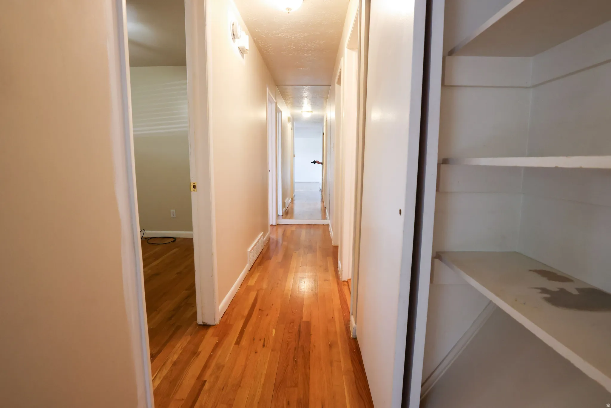 Hardwood-finish flooring, built-in shelving, and neutral wall tones