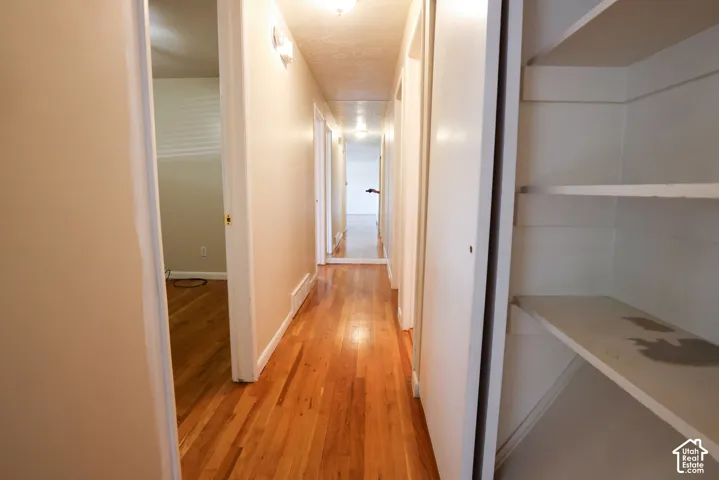 Hardwood-finish flooring, built-in shelving, and neutral wall tones