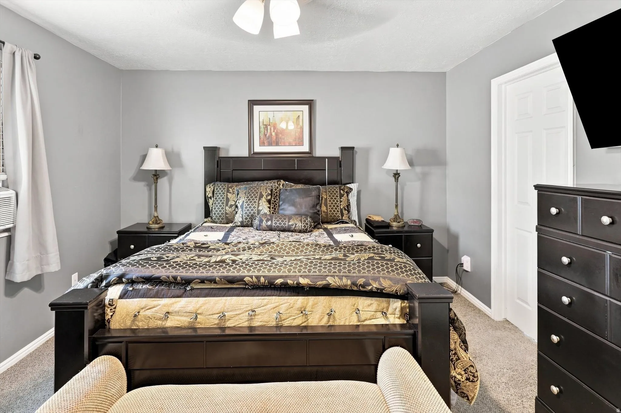 Neutral gray wall finish, white trim, and ceiling fan with lighting