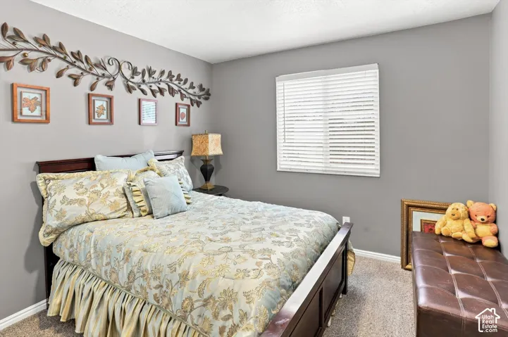 Room featuring neutral wall paint, a window with horizontal blinds, and carpeted flooring