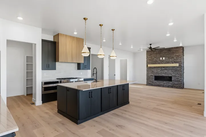 Spacious open-concept living area featuring light wood-finish flooring