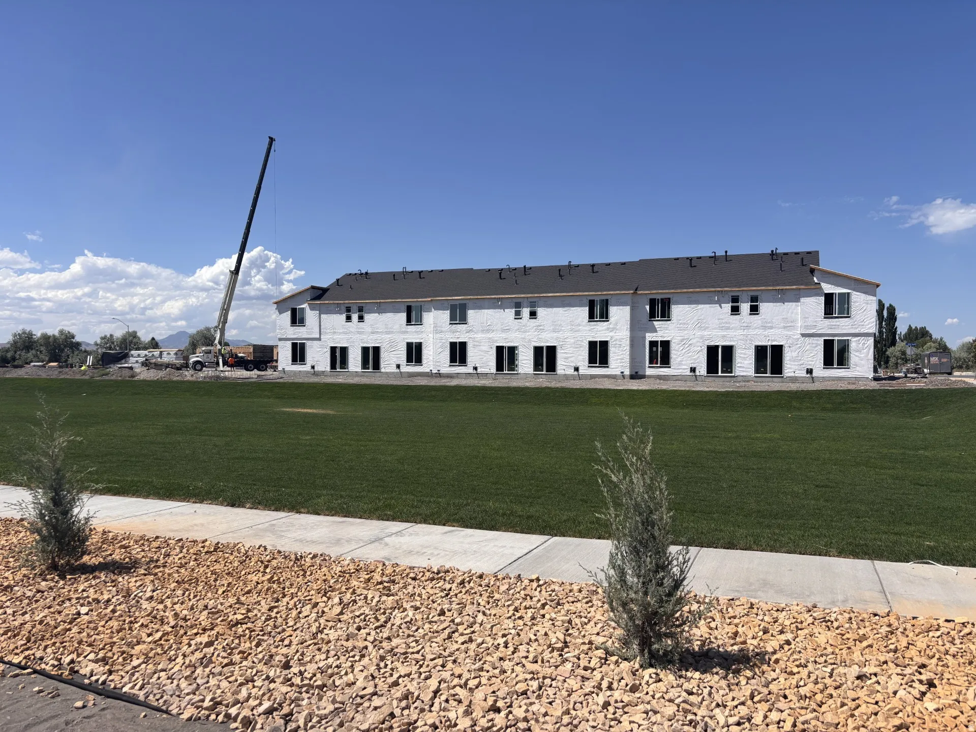This is the view from the back of the home! It is a large, beautifully maintained open green space, giving you a more open feel and plenty of room to enjoy the scenery.