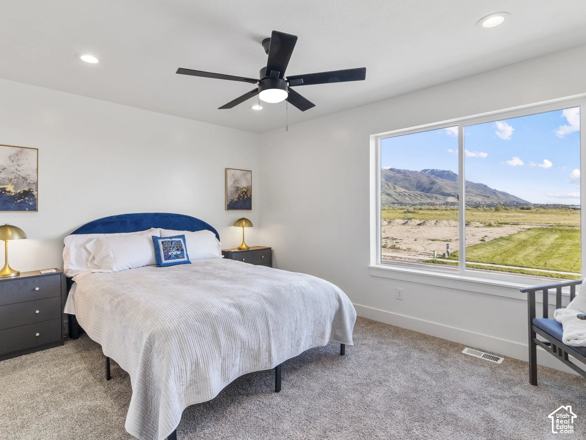 Large window offering mountain scenery, recessed lighting, ceiling fan, and carpeted flooring