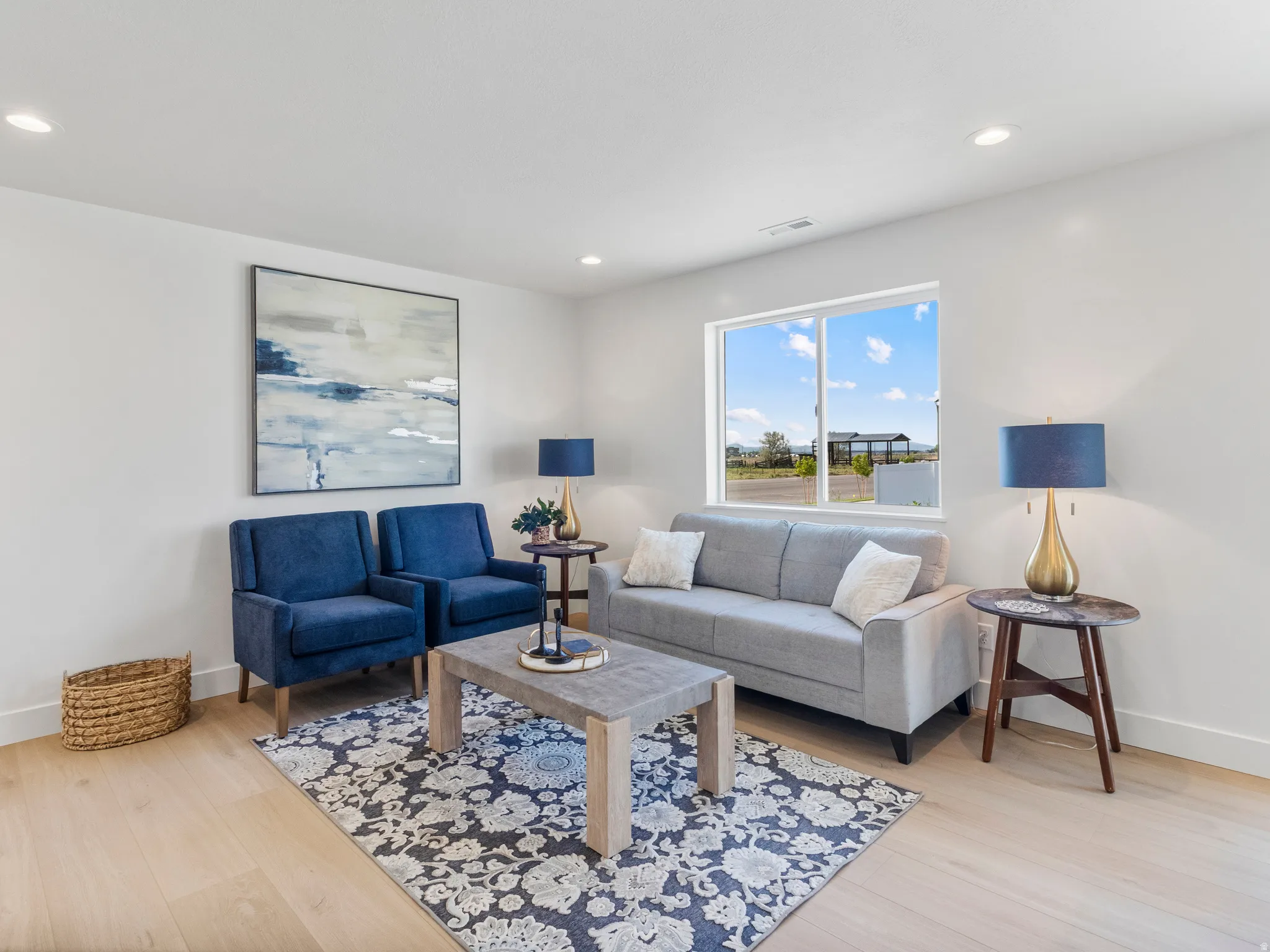 Recessed lighting, light wood-finish flooring, and a large window