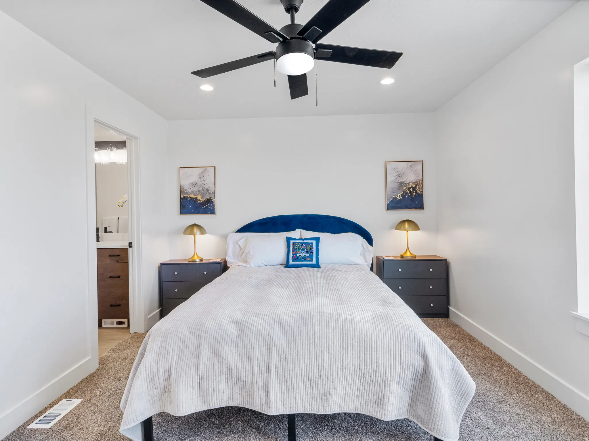 Recessed lighting, ceiling fan with integrated light, and neutral wall tones create a bright atmosphere