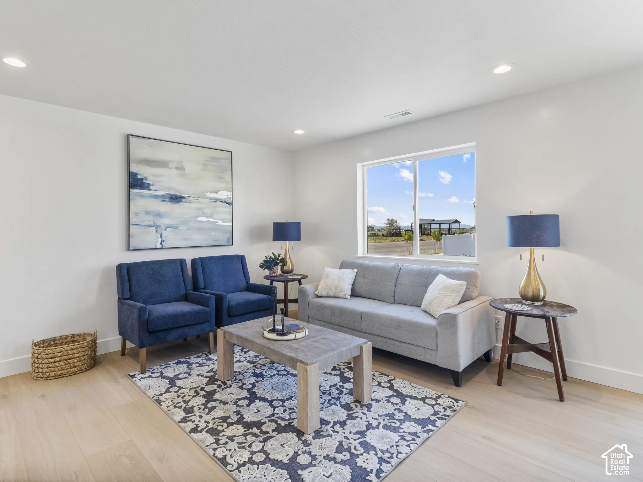 Recessed lighting, light wood-finish flooring, and a large window