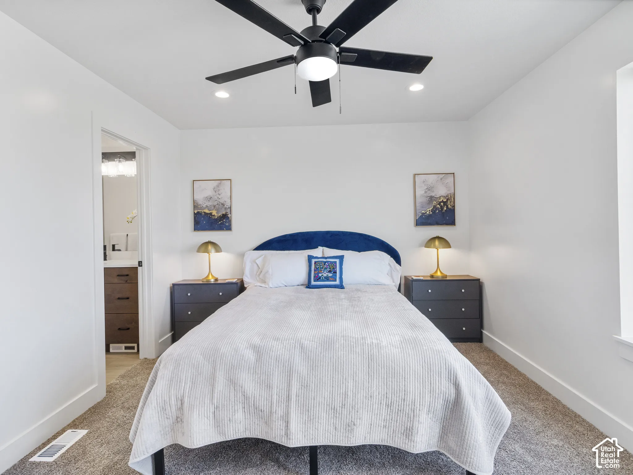 Recessed lighting, ceiling fan with integrated light, and neutral wall tones create a bright atmosphere