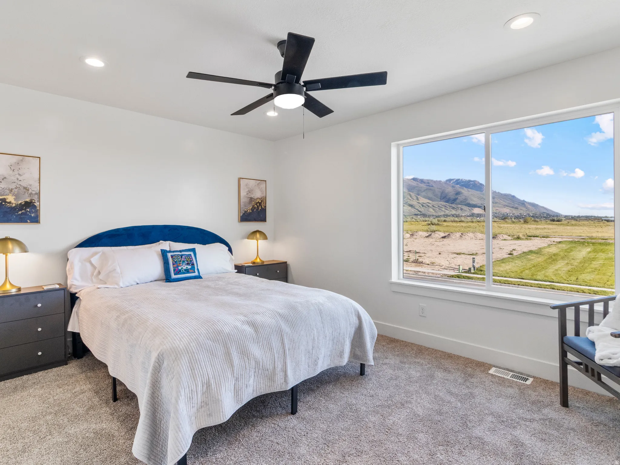 Large window offering mountain scenery, recessed lighting, ceiling fan, and carpeted flooring