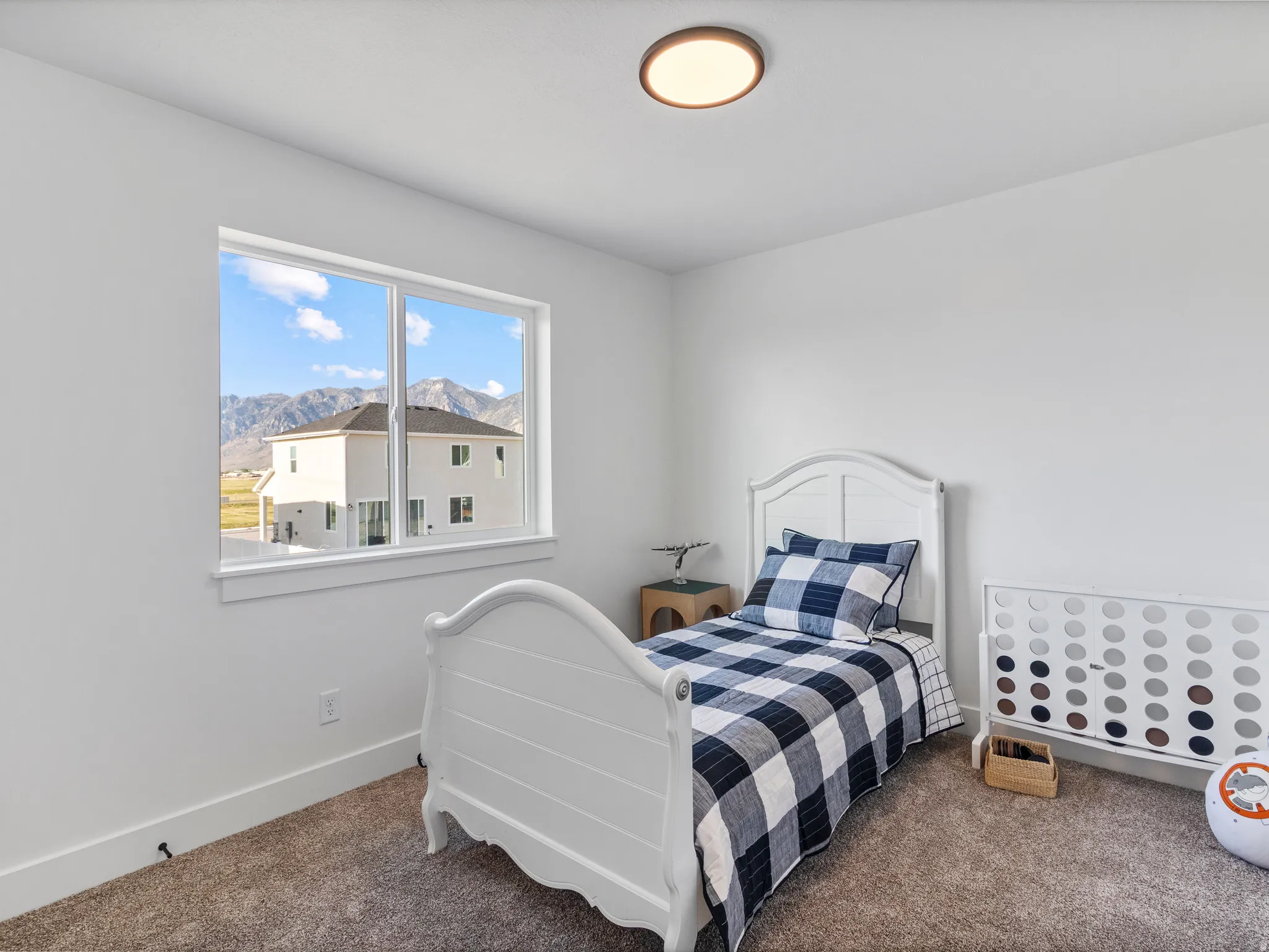 Recessed ceiling light fixture and a large window with white trim