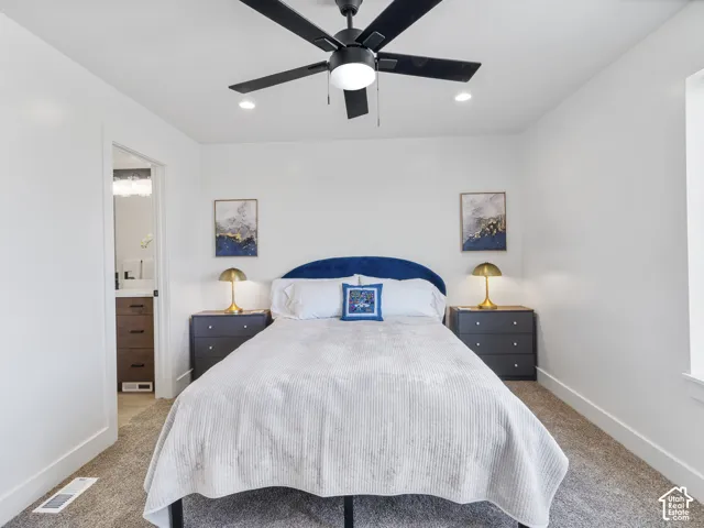 Recessed lighting, ceiling fan with integrated light, and neutral wall tones create a bright atmosphere