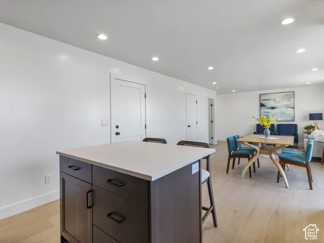 Central kitchen island with wood-finish cabinetry and light-toned countertop