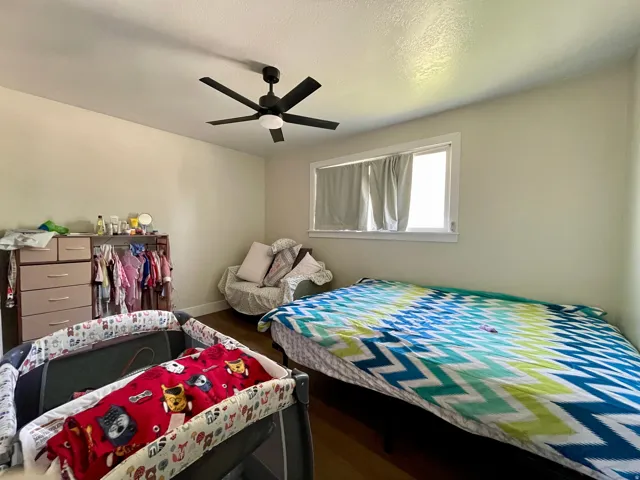 Recessed window with white trim, wood-finish flooring, and a ceiling fan with integrated lighting