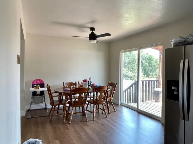 Wood-finish flooring with a ceiling fan light fixture