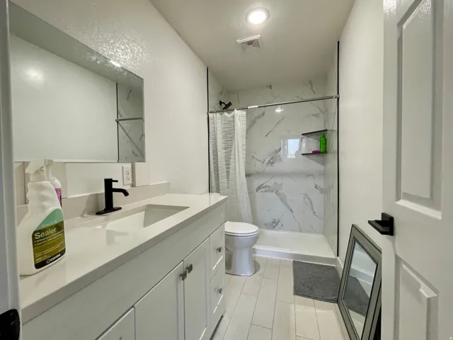 Vanity with an integrated sink and matte black faucet