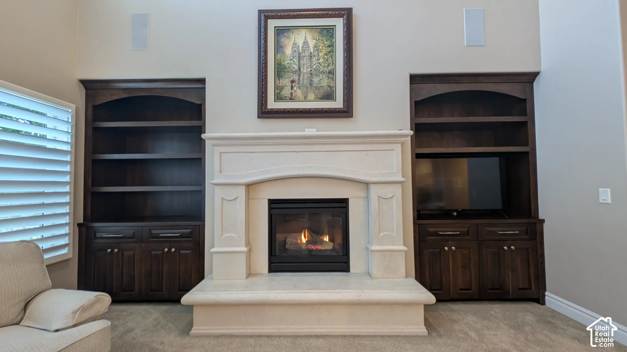 Built-in cabinetry flanking a stone fireplace