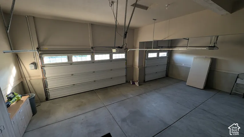Attached three car garage with overhead lighting and three automatic garage door openers