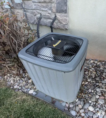 Amana brand HVAC unit with stone and stucco exterior elements