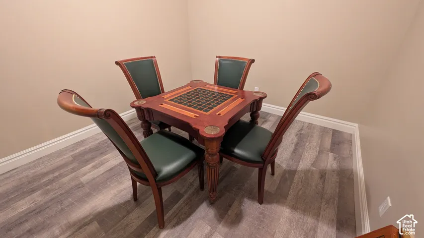 Fun game table available for purchase or included with full offer. Wood-finish flooring with light beige wall paint