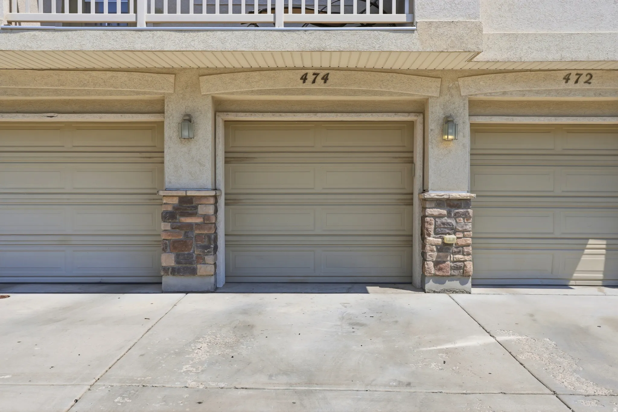 Attached garages with stone-clad columns, and exterior sconce lighting.  Garage door code and fob included