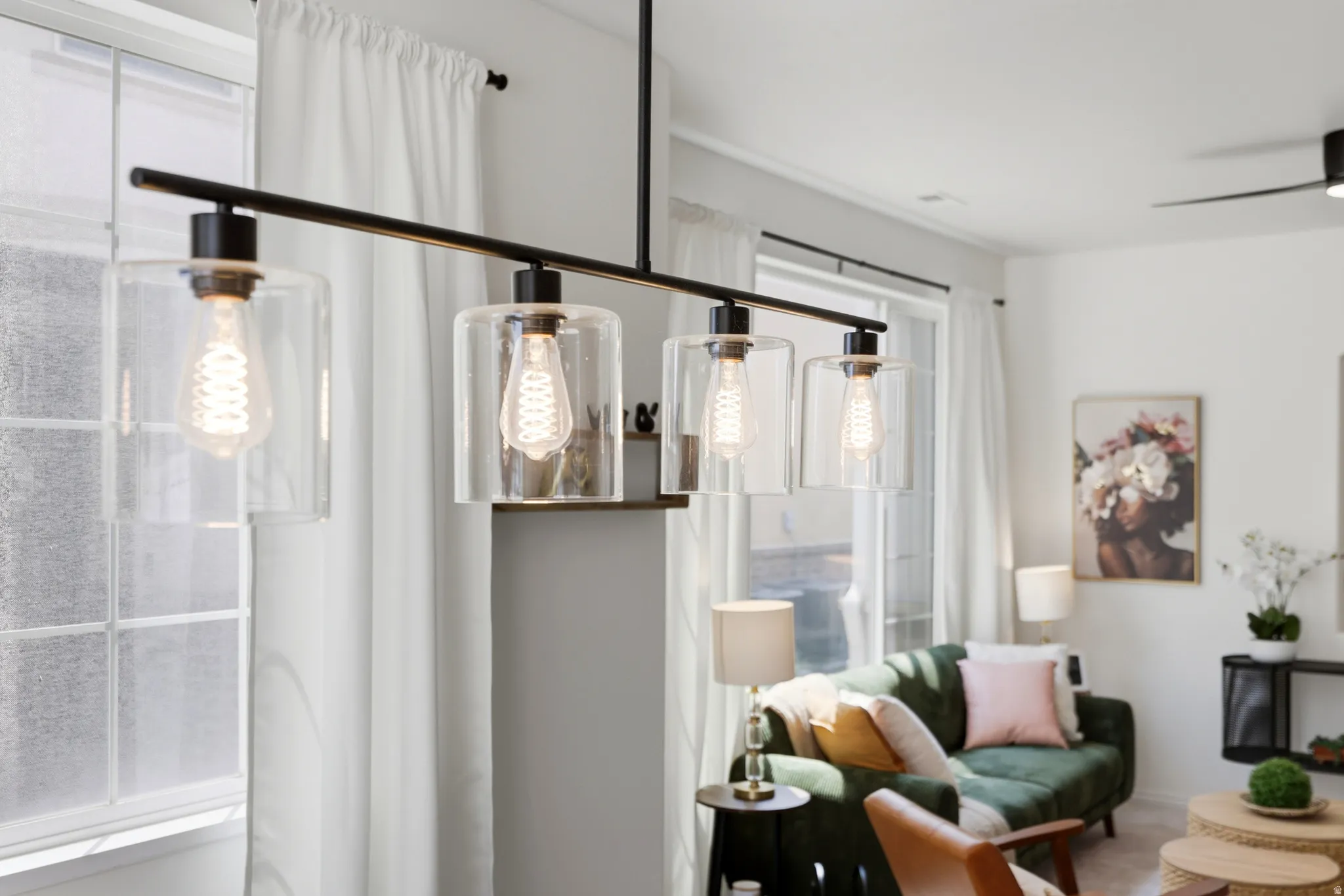 Linear chandelier with clear glass shades and exposed filament bulbs