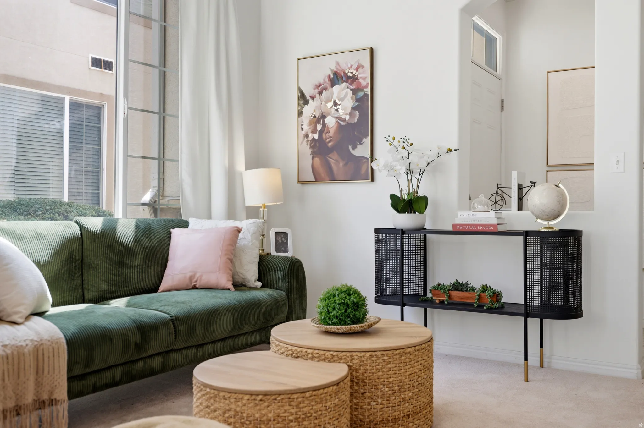 Expansive window with vertical panes, white wall finishes, and carpet flooring