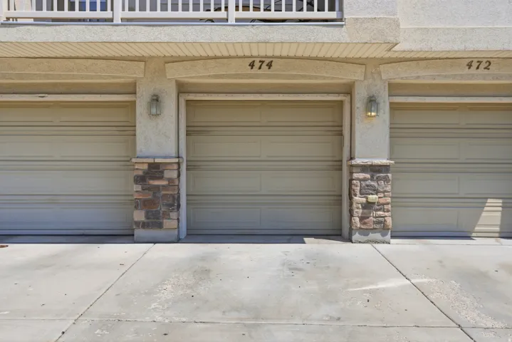 Attached garages with stone-clad columns, and exterior sconce lighting.  Garage door code and fob included