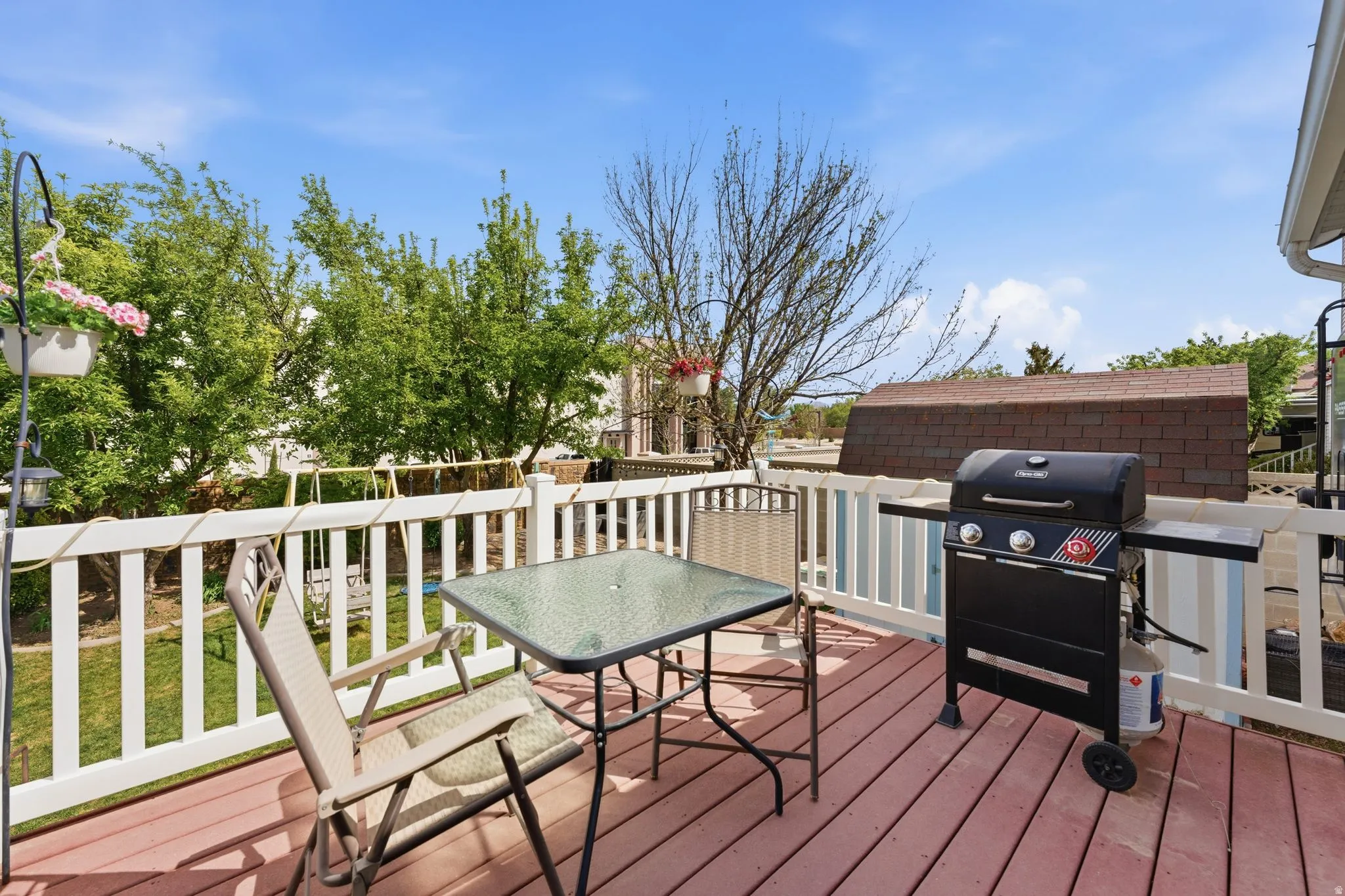 Expansive outdoor deck with wood-finish flooring and white railing