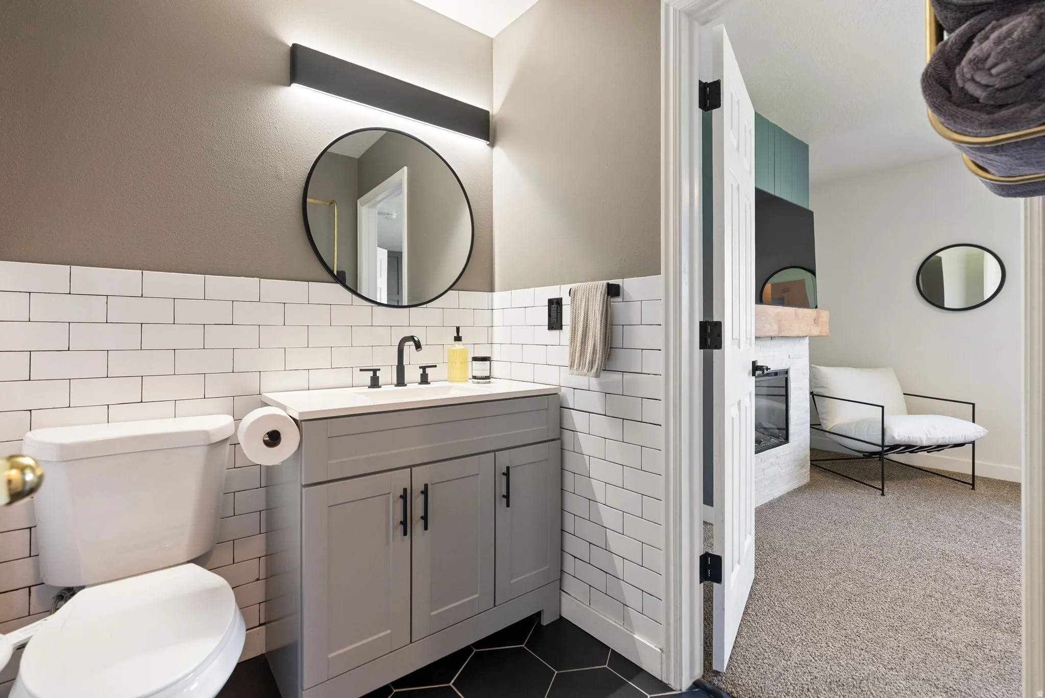 Vanity with a single sink, black faucet, and white countertop
